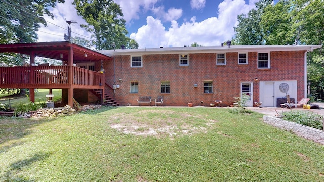 rear view of property with a lawn and a wooden deck