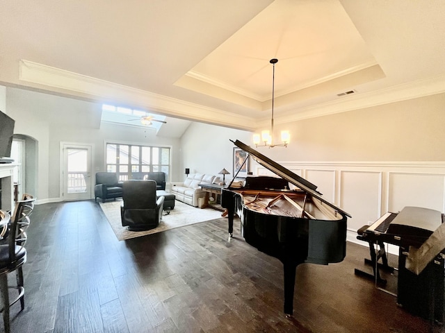 misc room with ornamental molding, ceiling fan, dark hardwood / wood-style flooring, and a tray ceiling