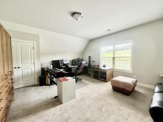 office space featuring vaulted ceiling and light colored carpet