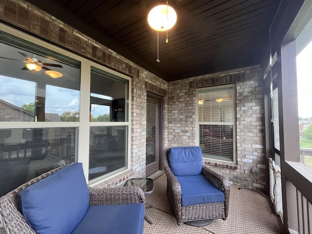 sunroom with wooden ceiling and ceiling fan