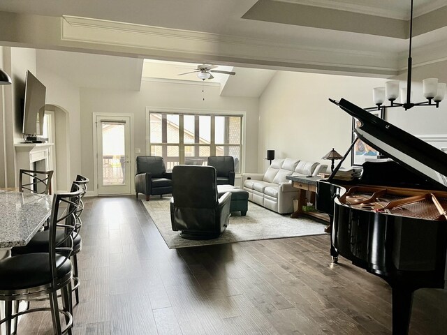 living room featuring dark hardwood / wood-style floors and ceiling fan with notable chandelier