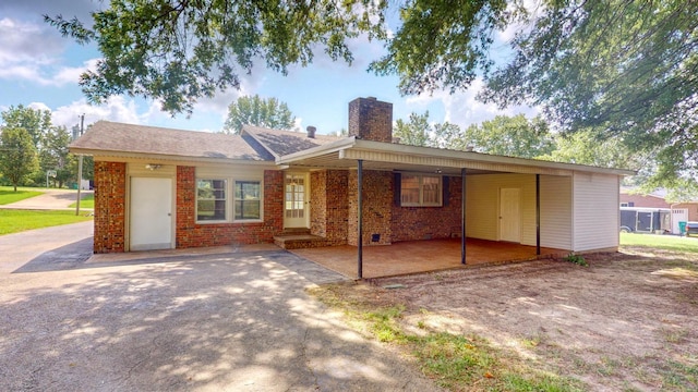 view of front of property featuring a carport