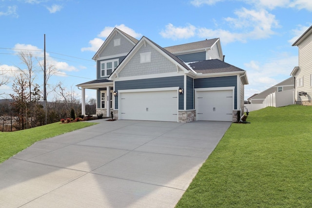 craftsman-style home featuring a garage, stone siding, driveway, and a front lawn