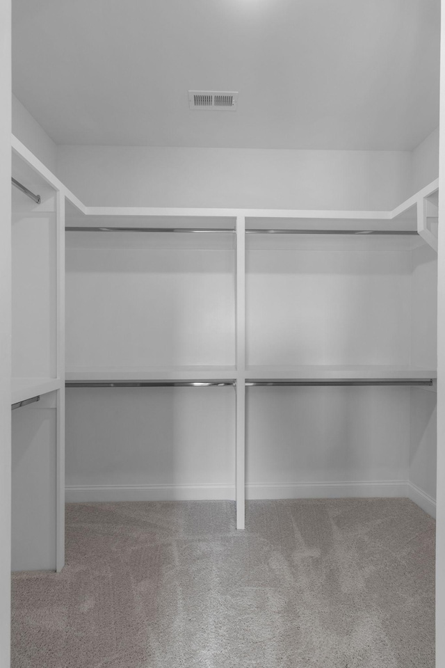 walk in closet with carpet floors and visible vents