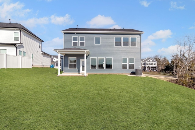 back of property with a patio, a lawn, and fence