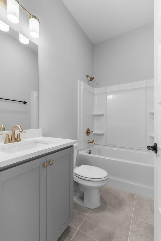 full bath featuring bathtub / shower combination, tile patterned flooring, vanity, and toilet