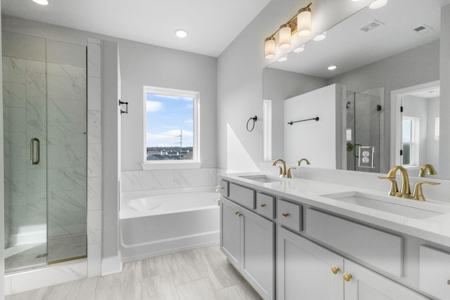 full bathroom with a garden tub, a shower stall, visible vents, and a sink