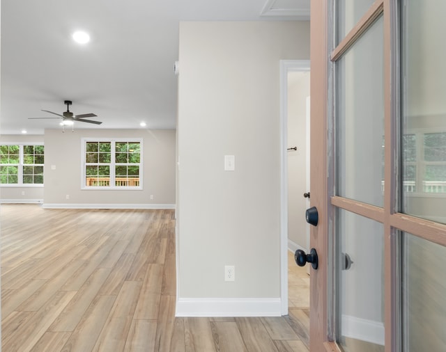 foyer with ceiling fan and light hardwood / wood-style floors