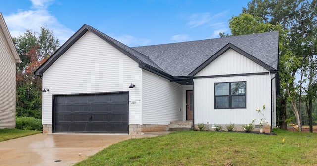 view of front of home with a garage and a front lawn