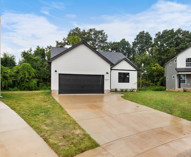 view of front of house with a garage and a front lawn