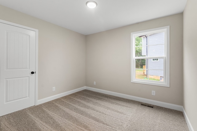 spare room with carpet floors and plenty of natural light