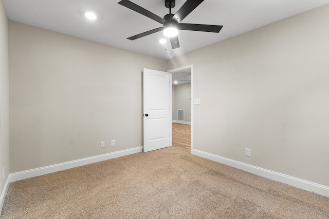 spare room with light carpet and ceiling fan