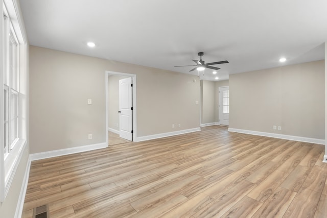 empty room with light hardwood / wood-style flooring and ceiling fan