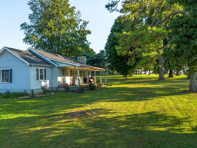 view of yard featuring covered porch