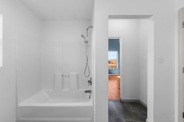 full bathroom featuring shower / tub combination and baseboards
