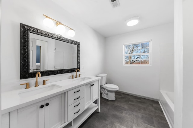 full bath with visible vents, a sink, toilet, and double vanity