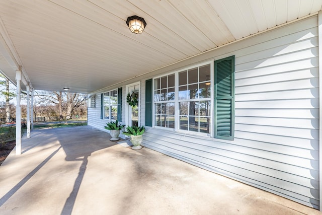 view of patio / terrace featuring covered porch and a carport