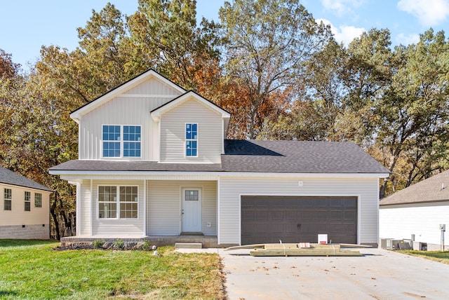 front of property featuring covered porch, cooling unit, a garage, and a front yard