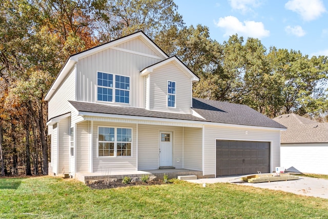 view of property with covered porch, a front yard, and a garage