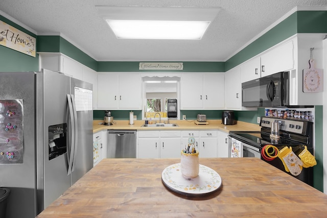 kitchen featuring white cabinetry, appliances with stainless steel finishes, sink, and butcher block counters