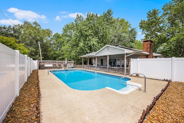 view of pool with an outdoor structure and a patio