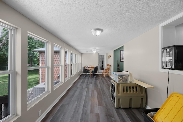 hall with dark hardwood / wood-style floors and a textured ceiling