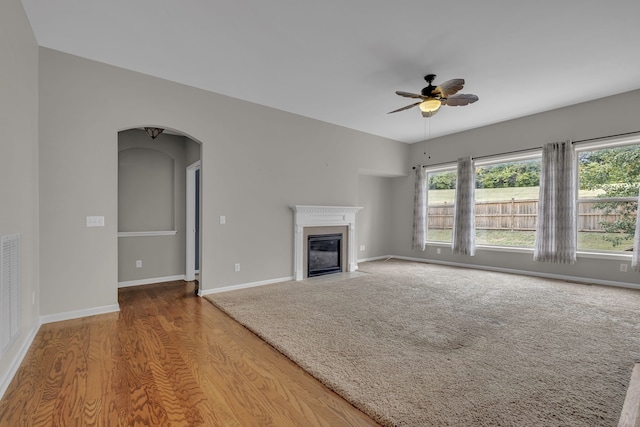 unfurnished living room with hardwood / wood-style floors and ceiling fan