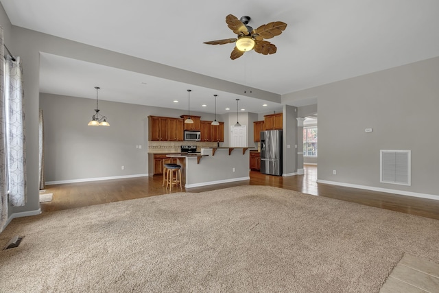 unfurnished living room with light hardwood / wood-style floors and ceiling fan