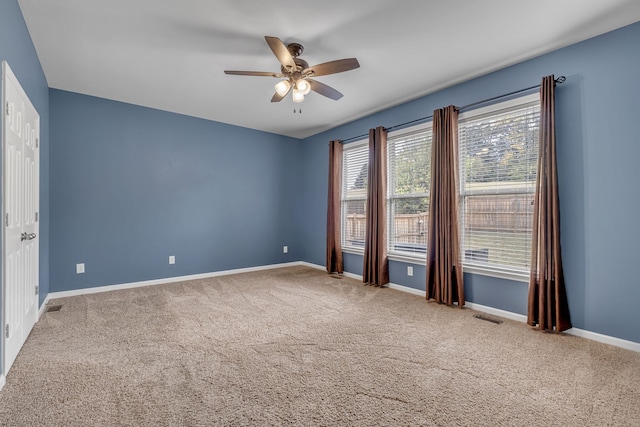 empty room featuring carpet and ceiling fan