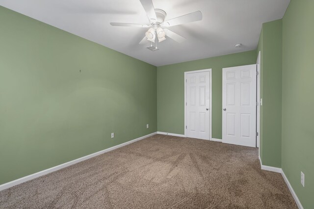 unfurnished bedroom featuring ceiling fan and carpet flooring