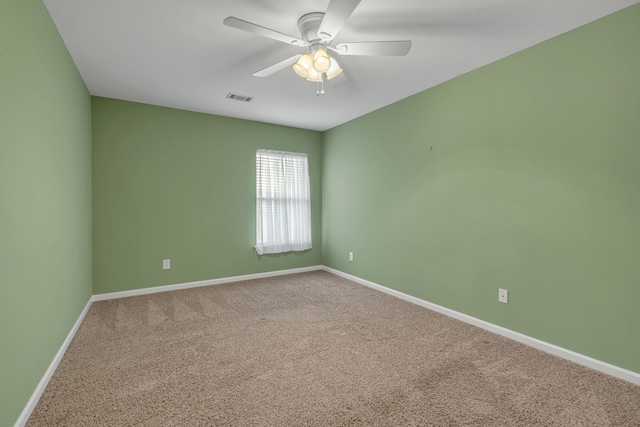 spare room with ceiling fan and carpet