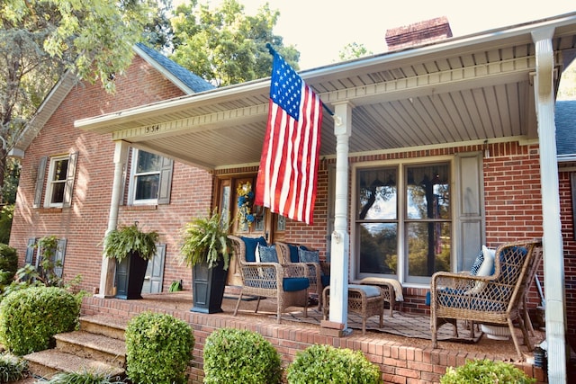 rear view of house with a porch