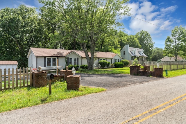 ranch-style house featuring a garage and a front yard