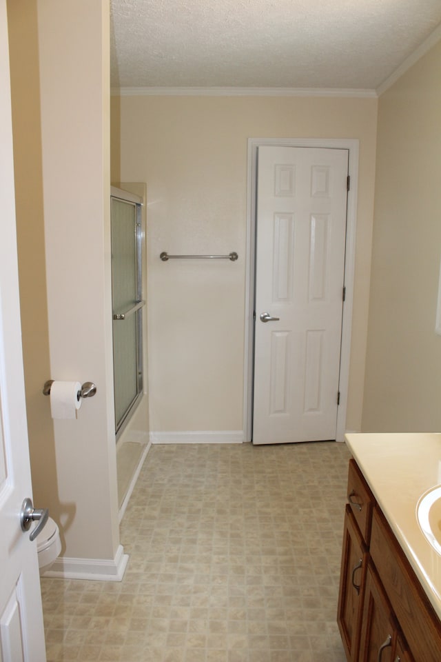 bathroom featuring vanity, toilet, tile patterned floors, and a textured ceiling