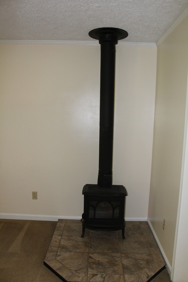 details with a textured ceiling, ornamental molding, and a wood stove