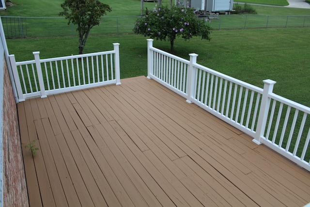 wooden deck featuring a yard