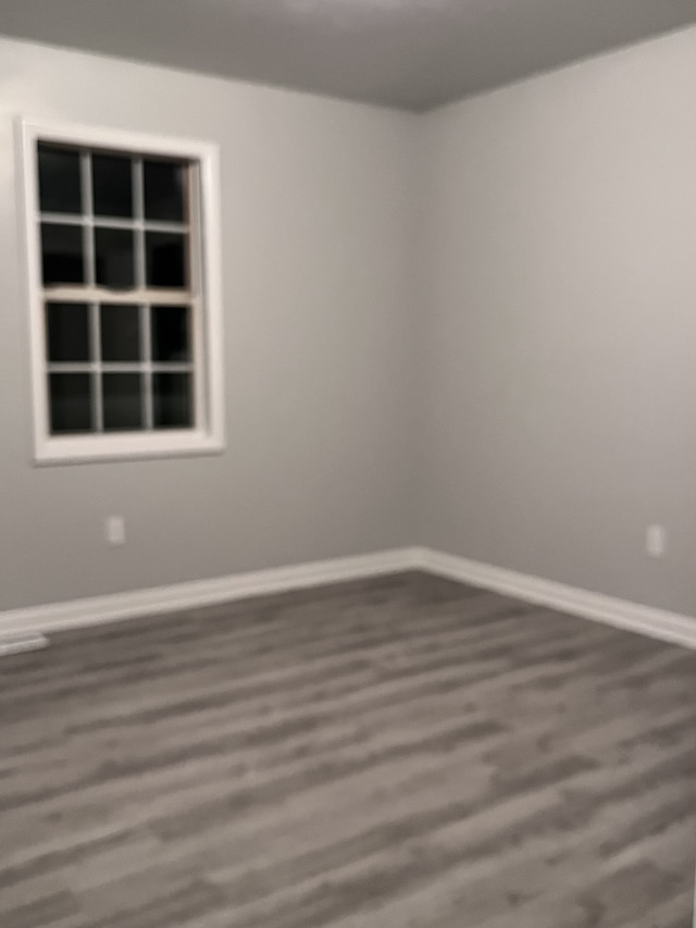 unfurnished room with hardwood / wood-style floors