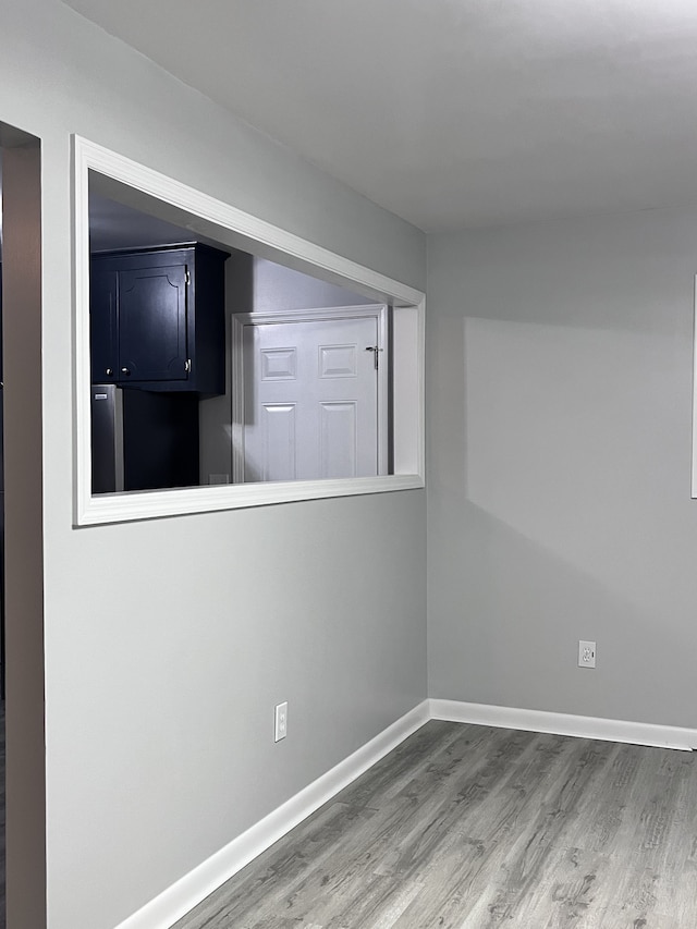 empty room with hardwood / wood-style flooring