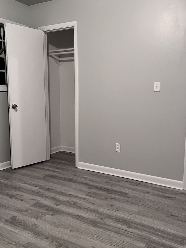 unfurnished bedroom with a closet and hardwood / wood-style floors