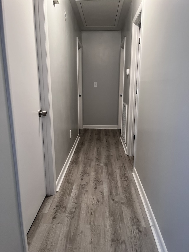 corridor featuring wood-type flooring