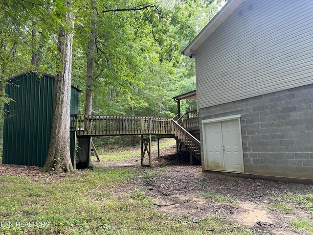 view of yard featuring stairs and a deck