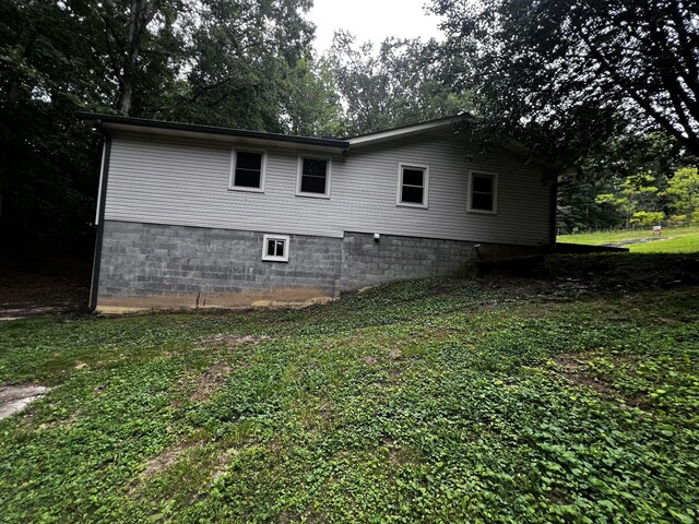 view of home's exterior with a yard