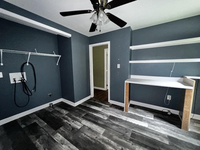 interior space featuring a ceiling fan, wood finished floors, and baseboards