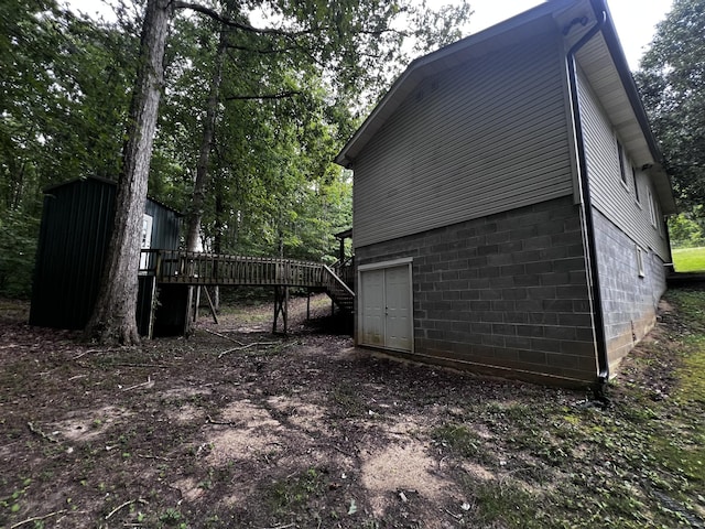 exterior space featuring stairway and a wooden deck