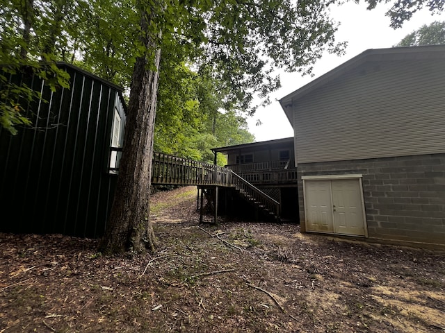 view of yard with a deck and stairway