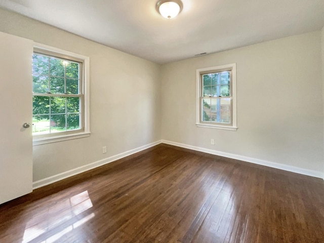 unfurnished room featuring dark hardwood / wood-style floors