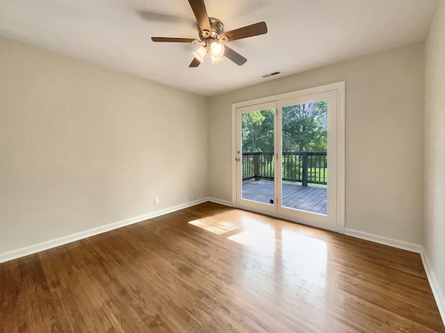 unfurnished room featuring ceiling fan and dark hardwood / wood-style flooring