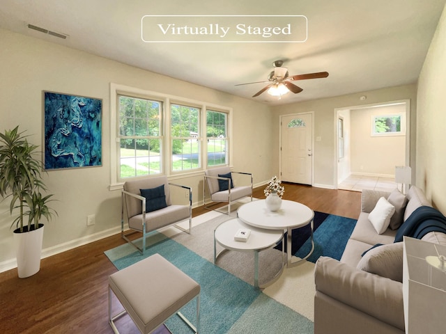 living room featuring wood-type flooring and ceiling fan