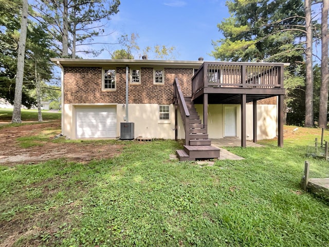 back of property with cooling unit, a garage, a lawn, and a deck