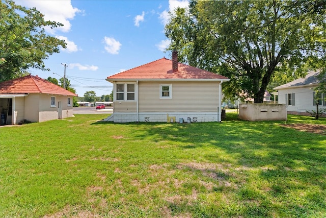 back of property featuring a lawn